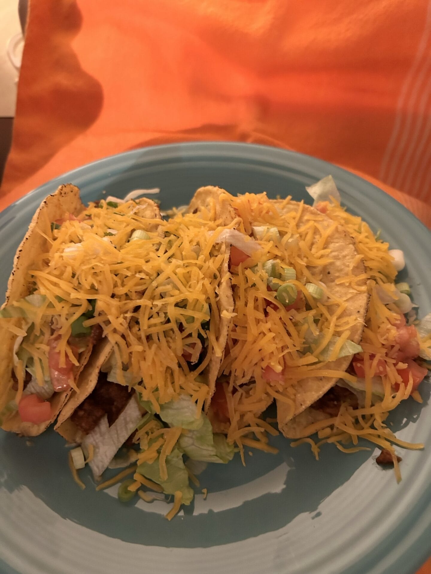 Fully loaded tacos on a blue plate